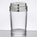 A clear glass cheese shaker with a metal lid.