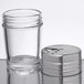 An American Metalcraft clear glass shaker with an adjustable stainless steel lid.