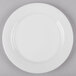 A white bone china side plate with a white rim.