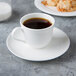 A cup of coffee on a Reserve by Libbey bone china coffee saucer.