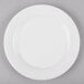 A white bone china dinner plate with a white rim.