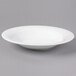 A white Reserve by Libbey bone china round soup bowl on a gray surface.