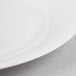 A close up of a Reserve by Libbey International bone china round plate with a white rim.