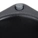 A close up of a black plastic cylinder with a hole.