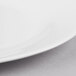 A white bone china oval platter with a white rim.