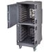 A large metal Cambro food holding cabinet with two compartments and wheels.