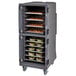 A Cambro Pro Cart Ultra food holding cabinet in a large metal cart with trays of food.
