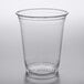 A Fabri-Kal Greenware clear plastic cup with a clear rim on a table.