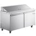 An Avantco stainless steel refrigerated sandwich prep table with two doors on wheels.