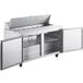 An Avantco stainless steel refrigerated sandwich prep table with two open doors.