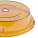A yellow plastic Cambro Camwear plate cover with a hole in it.