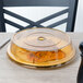A Cambro amber low profile plate cover on a plate with food.