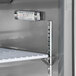 An Avantco stainless steel sandwich prep refrigerator with a thermometer on a shelf.