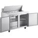An Avantco stainless steel refrigerated sandwich prep table with two open doors.