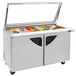 A Turbo Air stainless steel refrigerated sandwich prep table with glass lids open over trays of food.