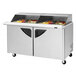 A Turbo Air refrigerated sandwich prep table with sliding lids open to food.