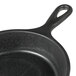 A black faux cast iron Elite Global Solutions fry pan with a handle.
