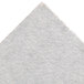 A white baking stone surface with a small triangle on it.