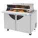 A Turbo Air 2 door stainless steel refrigerated sandwich prep table with food inside.