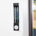 A Taylor indoor/outdoor thermometer on a wall.