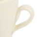An Elite Global Solutions antique white melamine coffee mug with a handle.