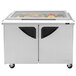 A Turbo Air refrigerated sandwich prep table with glass lids over the refrigerated area.
