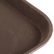 A close-up of a brown Carlisle Griptite 2 non-skid serving tray.