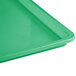 A green Winholt polystyrene display tray on a table.