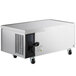 An Avantco stainless steel refrigerated chef base with black wheels.