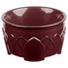 A red bowl with a carved design.