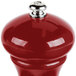 A Fletchers' Mill Marsala cinnabar pepper mill with a silver top on a red surface.