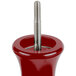 A close-up of a red Fletchers' Mill Marsala pepper mill with a screw in a red holder.
