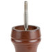 A Fletchers' Mill walnut stained wooden pepper mill with a metal screw in it.