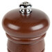A Fletchers' Mill walnut stain wooden pepper mill with a metal top.