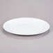 A white oval melamine platter with a rim.