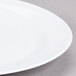 A white oval melamine platter with a rim.