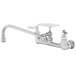 A silver T&S wall mounted pantry faucet with soap dish.