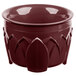 A red Dinex insulated bowl with a carved design.