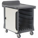 A granite gray plastic Cambro meal delivery cart with trays behind a door.