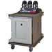 A Cambro granite sand meal delivery cart with white and black plastic trays on it.