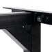 A black metal Lancaster Table & Seating cantilever table bracket with a screw on it.