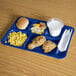 A blue Carlisle 6 compartment tray with food on it.