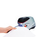 A person using a Swingline Optima 70 electric stapler to staple a piece of paper.