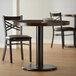 A table with a Lancaster Table & Seating Standard Height Table Base Column and Rod.