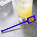 A glass of lemonade with a WNA Comet blue rectangular stirrer.
