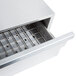 A stainless steel drawer with a grate on top for APW Wyott HR-31 Series Hot Dog Roller Grill buns.