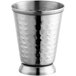 An Acopa Alchemy stainless steel mint julep cup with hammered detailing on the base.