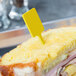 A sandwich with a WNA Comet yellow plastic pick in the middle.