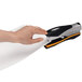 A person's hand using a Swingline Optima 40 stapler with a black and orange handle.