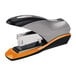 A black and orange Swingline stapler with a white box in the background.